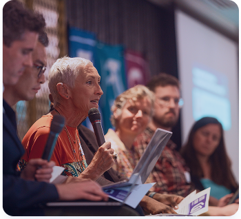 image of a conference panel of speakers